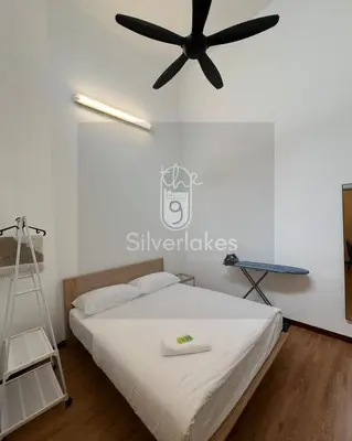 a bedroom with a bed with a ceiling fan at The9 Silverlakes Homestay in Batu Gajah