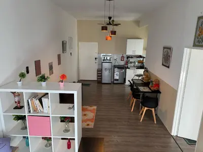 a living room with a kitchen and a dining room at 100MBps Unifi Ipoh Anderson Residence Tatami AA2 in Ipoh