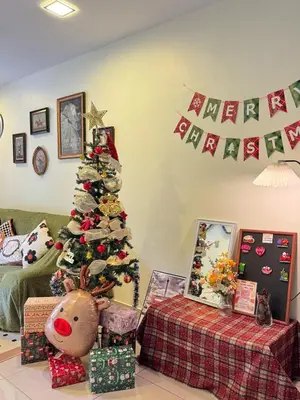 a christmas tree in a living room with presents at Tea Valley & Farm View at Cool Summer Cameron in Cameron Highlands