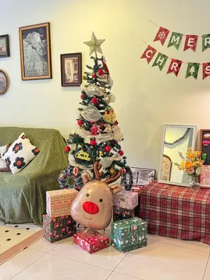 a christmas tree in a living room with presents at Tea Valley & Farm View at Cool Summer Cameron in Cameron Highlands