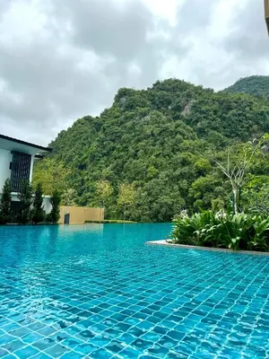 a swimming pool with a mountain in the background at Sunway Onsen Suite in Tambun