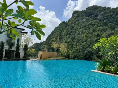 a swimming pool with a mountain in the background at Sunway Onsen Suite in Tambun