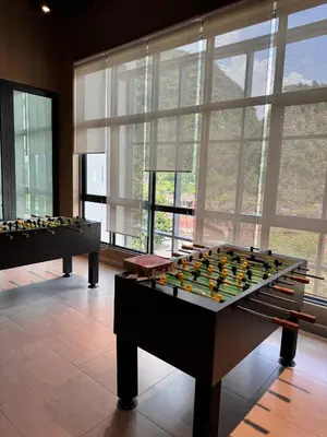 two foosball tables in a room with windows at Sunway Onsen Suite in Tambun