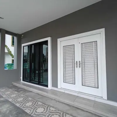 two white doors in a room with a rug at LYL Journey House at Ipoh Town Centre 17PAX 6BR in Ipoh