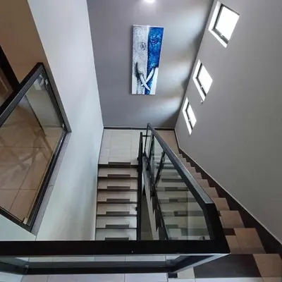 a staircase in a building with a painting on the wall at LYL Journey House at Ipoh Town Centre 17PAX 6BR in Ipoh