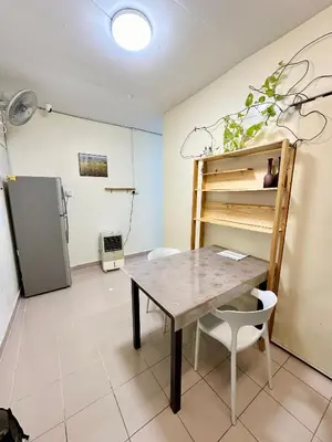 a dining room with a table and a refrigerator at K Inn 55 in George Town