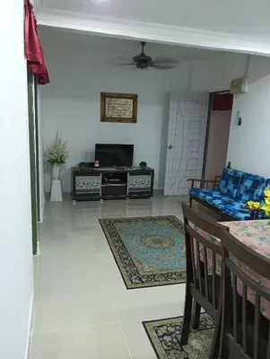 a living room with a couch and a tv at Yaakub homestay pangsapuri sutera jaya in Perai