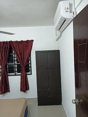 a room with a black cabinet and a window at Yaakub homestay pangsapuri sutera jaya in Perai