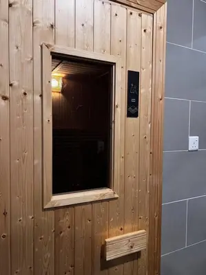 a wooden wall with a window in a room at ONSTAY Sunway Onsen Suites in Ipoh