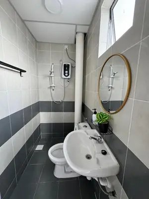 a bathroom with a sink and a toilet and a mirror at DADDY HOMES 2 Emerald Avenue Centrum BRINCHANG VIEW in Brinchang