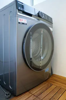 a washing machine sitting on top of a wooden floor at Bunny's Warm Penthouse by Comfy Sofy in Brinchang