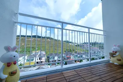 two stuffed rabbits sitting on a balcony with a view at Bunny's Warm Penthouse by Comfy Sofy in Brinchang