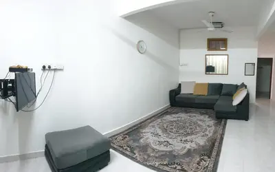 a living room with a couch and a tv at Nuha Kulim Hitech Homestay Islamic in Kulim