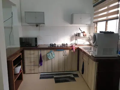 a kitchen with a microwave and a counter top at Nuha Kulim Hitech Homestay Islamic in Kulim