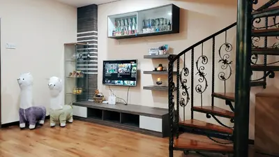 a living room with a tv on a wall at Cameron Brinchang 5 Min to Centrum 12pax Duplex Shophouse by City Home Empire in Brinchang