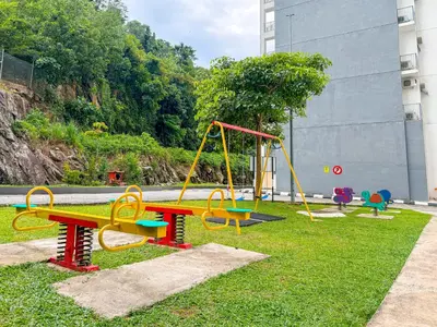 a playground with colorful swings in a park at Crystal Creek 3BR Condo near Taiping Lake Garden & Zoo with WiFi Netflix in Taiping
