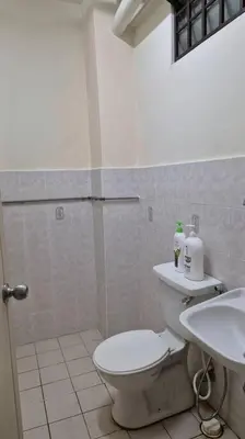 a bathroom with a toilet and a sink at Taman Sunway Tunas in Bayan Lepas