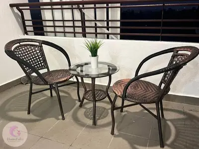 two chairs and a glass table on a balcony at The Majestic Condo Ipoh Home Fairy 4 in Ipoh