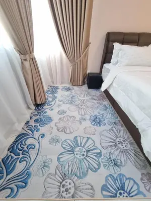a bedroom with a bed with a blue and white blanket at NuTiQa Homestay Meru Ipoh Perak in Ipoh