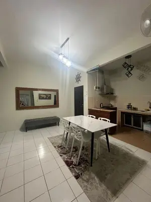 a kitchen with a table and chairs in a room at Dsyahna homestay in Ipoh