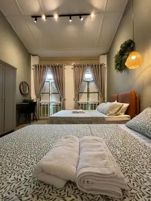 a large bedroom with two beds with towels on them at New! 9 pax Georgetown Heritage Pre-war House 3BR in George Town