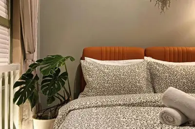 a bedroom with a bed with pillows and a plant at New! 9 pax Georgetown Heritage Pre-war House 3BR in George Town
