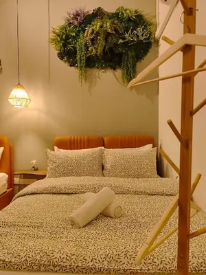 a bed with a towel laying on top of it at New! 9 pax Georgetown Heritage Pre-war House 3BR in George Town