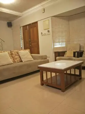 a living room with a couch and a coffee table at Bayan Baru in Bayan Lepas