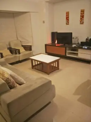 a living room with a couch and a coffee table at Bayan Baru in Bayan Lepas