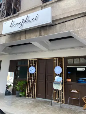 a store front with a sign above the doors at Homs Female Hostel in George Town