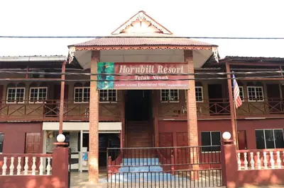 a building with a sign that reads houston resort at Hornbillbay Beach Resort in Kampung Teluk Nipah