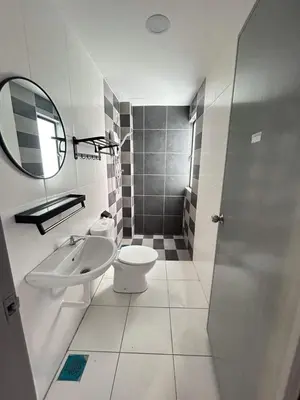 a bathroom with a sink and a toilet and a mirror at Booyen hills in Tanah Rata