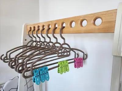 a wooden rack with colorful clothespins hanging on a wall at Seaview Studio Tropicana 218 Macalister Georgetown in George Town