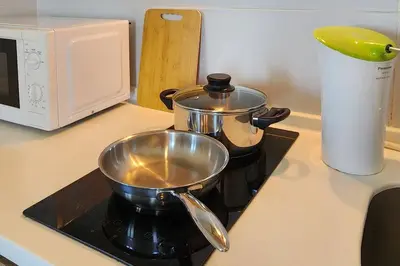 a pot and a pan on top of a stove at Seaview Studio Tropicana 218 Macalister Georgetown in George Town