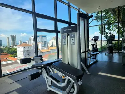 a gym with a treadmill and a view of a city at Seaview Studio Tropicana 218 Macalister Georgetown in George Town