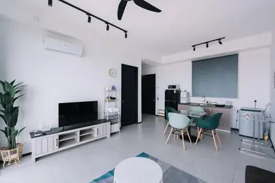 a white living room with a table and chairs at Seaview Infinity Pool 3BR 2Carparks 8Pax 401 in Jelutong