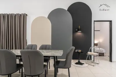 a dining room with a table and chairs and a mirror at Black & White 4BR Semi-D Home for 10 Guests with Pool Table Games & Free Netflix WiFi in Taiping