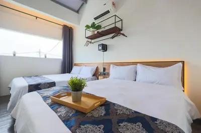 a hotel room with two beds with a tray on it at 35 Cozy Homestay with projector Pool BBQ evcharger in Ipoh