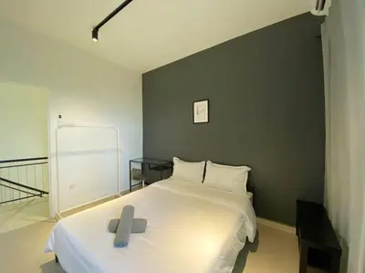 a bedroom with a white bed with a cross on it at IKEA Modernism House 10Pax`Near Icon City in Bukit Mertajam