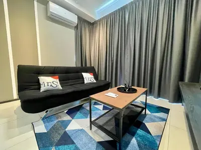 a living room with a black couch and a table at Industrial Style 2 Bedroom Unit Urban Suites Georgetown Sea View Jelutong in Jelutong