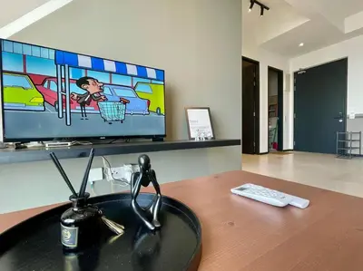 a desk with a television and a sink in a room at Industrial Style 2 Bedroom Unit Urban Suites Georgetown Sea View Jelutong in Jelutong