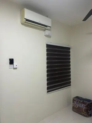 a room with a air conditioner on the wall at SKV Homestay in Teluk Intan