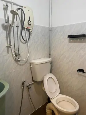 a bathroom with a toilet and a shower at Aayu Muntri - 4 mins to Chulia St George Town in George Town