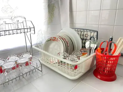 a dish rack with plates and utensils on a counter at Ipoh Comfortable Family Homestay 4R3B 12pax SY25 in Ipoh