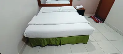 a bedroom with two beds in a room at Kampar Times Inn Hotel in Kampar