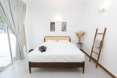 a bedroom with a bed and a large window at Tanjung Bungah 5BR Villa w pool 20pax in Tanjung Bungah