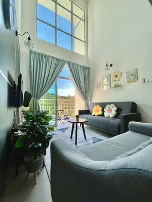 a living room with a couch and a large window at Aloft Cameron Highlands C in Brinchang