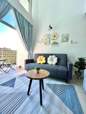 a living room with a blue couch and a table at Aloft Cameron Highlands C in Brinchang