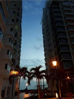 two tall buildings with palm trees and a street light at Sekinchan Fragrance \u82ac\u82b3\u6c11\u5bbf in Sekincan