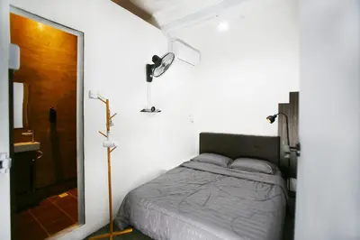 a small bedroom with a bed and a mirror at HangoutSpacez Queensbay at Bayan Lepas Penang in Bayan Lepas